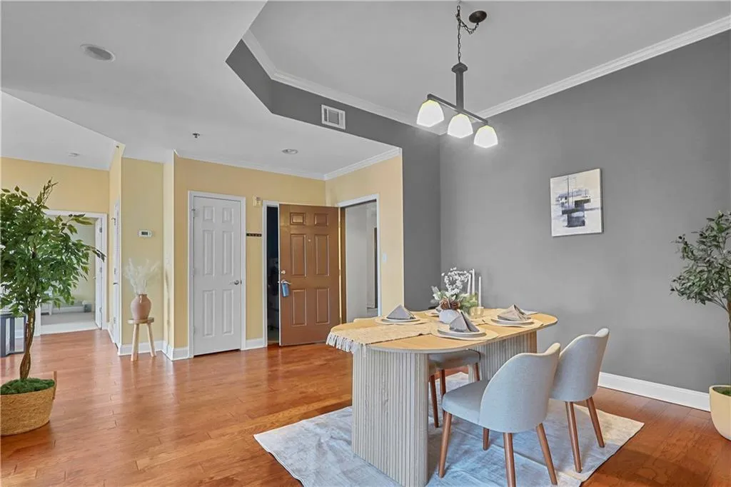 Dining area featuring wood finished floors and ornamental molding