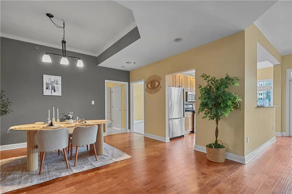 Dining area featuring ornamental molding and light wood-type flooring