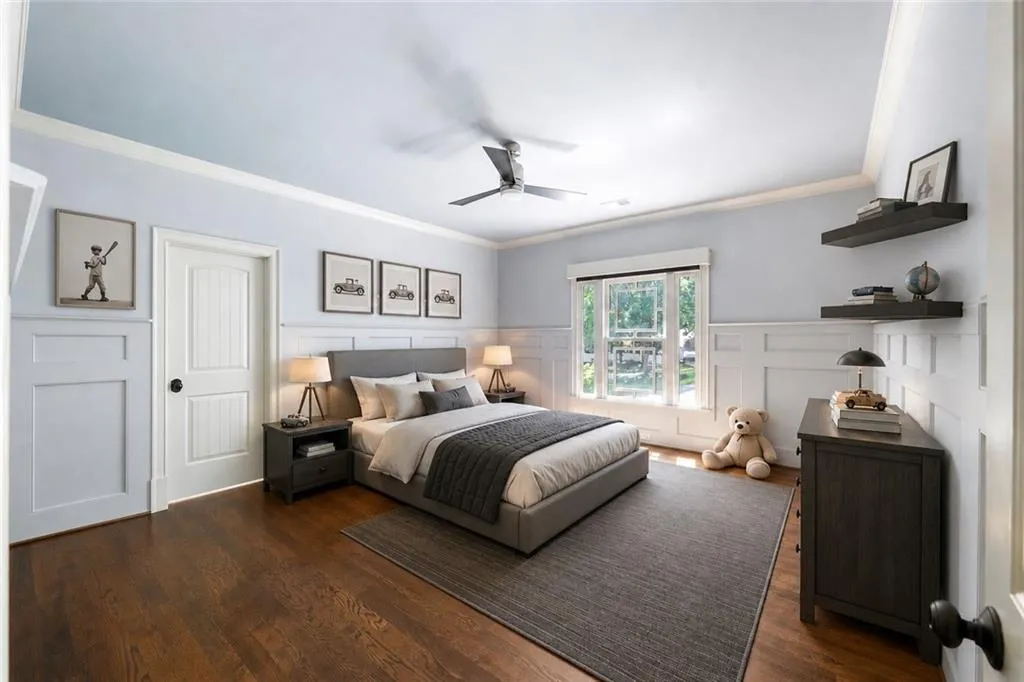Hardwood flooring, crown molding, wainscoting, ceiling fan, and large window