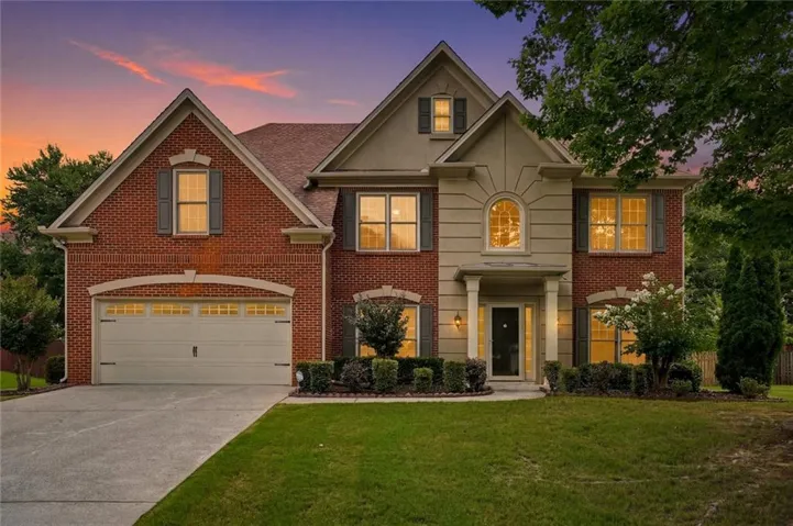 Brick and stucco exterior with multiple gables and a covered entry