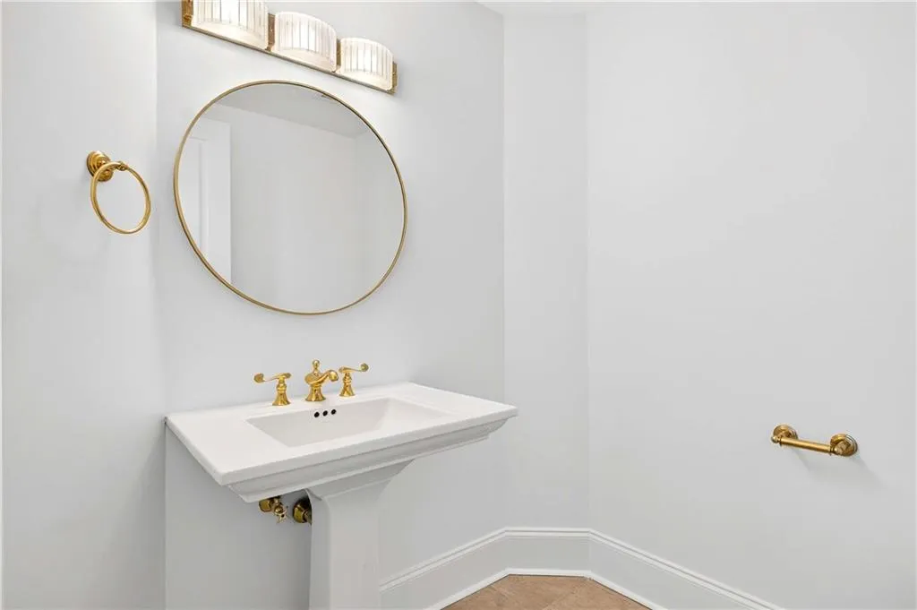 Bathroom with baseboards and light tile patterned floors
