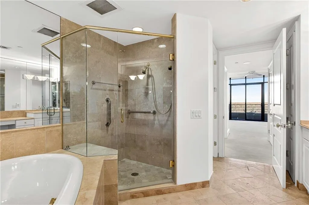 Full bathroom featuring a bath, a shower stall, and vanity