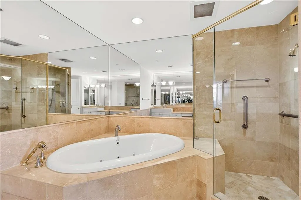Bathroom featuring a shower stall and a whirlpool tub