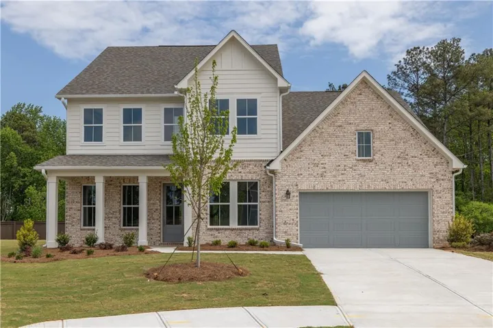 Brick and siding exterior with a covered porch