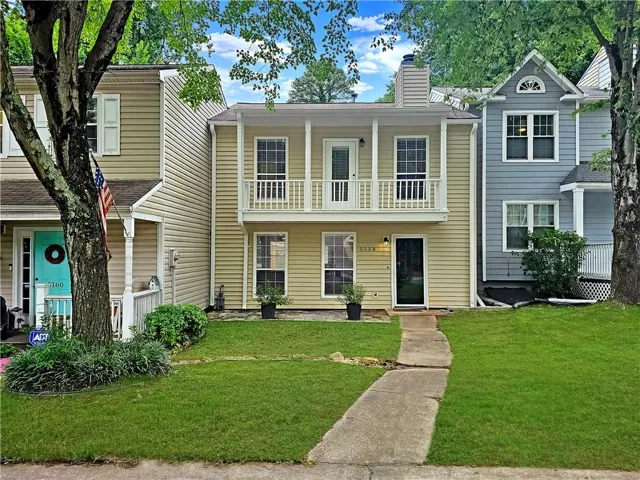 Two-story residence featuring a front entry with a balcony above