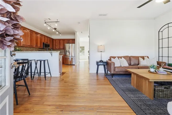Open-concept living area with wood-finish flooring
