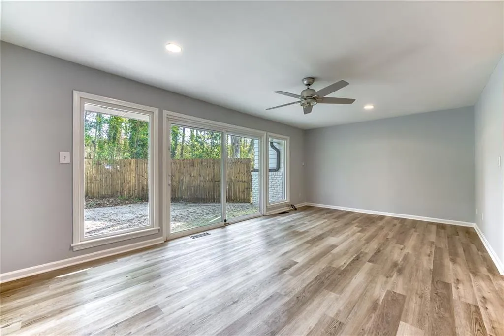 Spare room featuring ceiling fan and light hardwood / wood-style flooring