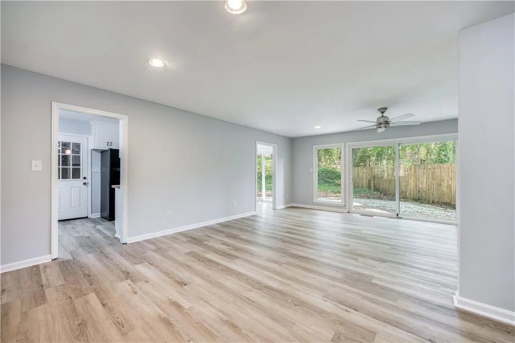 Spare room featuring ceiling fan and light hardwood / wood-style floors