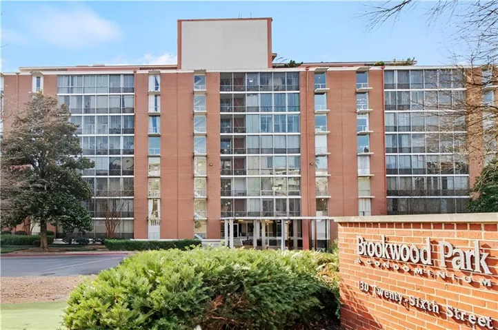 High-rise condominium building featuring a brick facade and extensive window lines