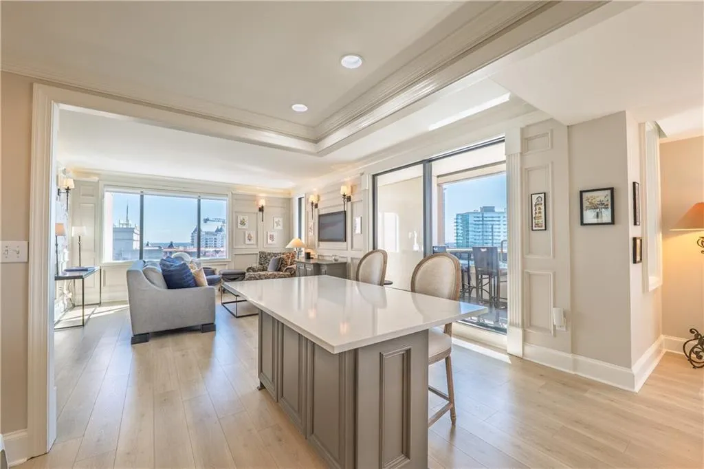 Kitchen featuring light wood-style floors, plenty of natural light, and a kitchen bar