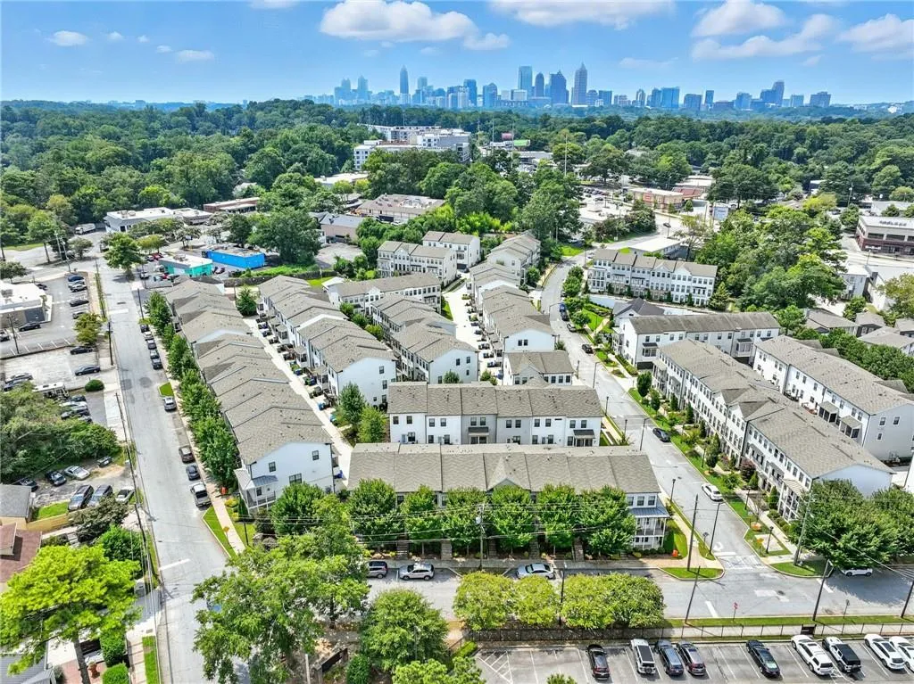 Drone / aerial view of city skyline and a tree filled landscape