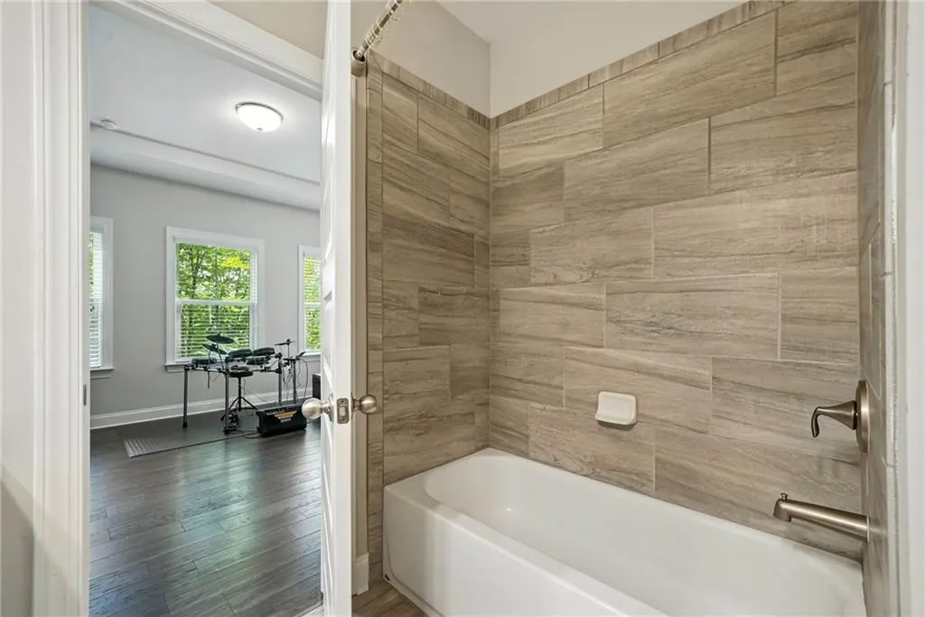 Full bathroom with bathtub / shower combination and wood finished floors