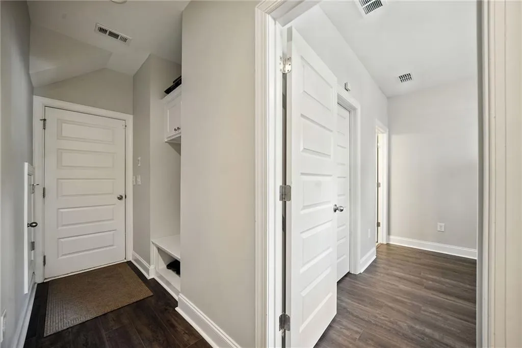 Mudroom featuring baseboards and dark wood finished floors