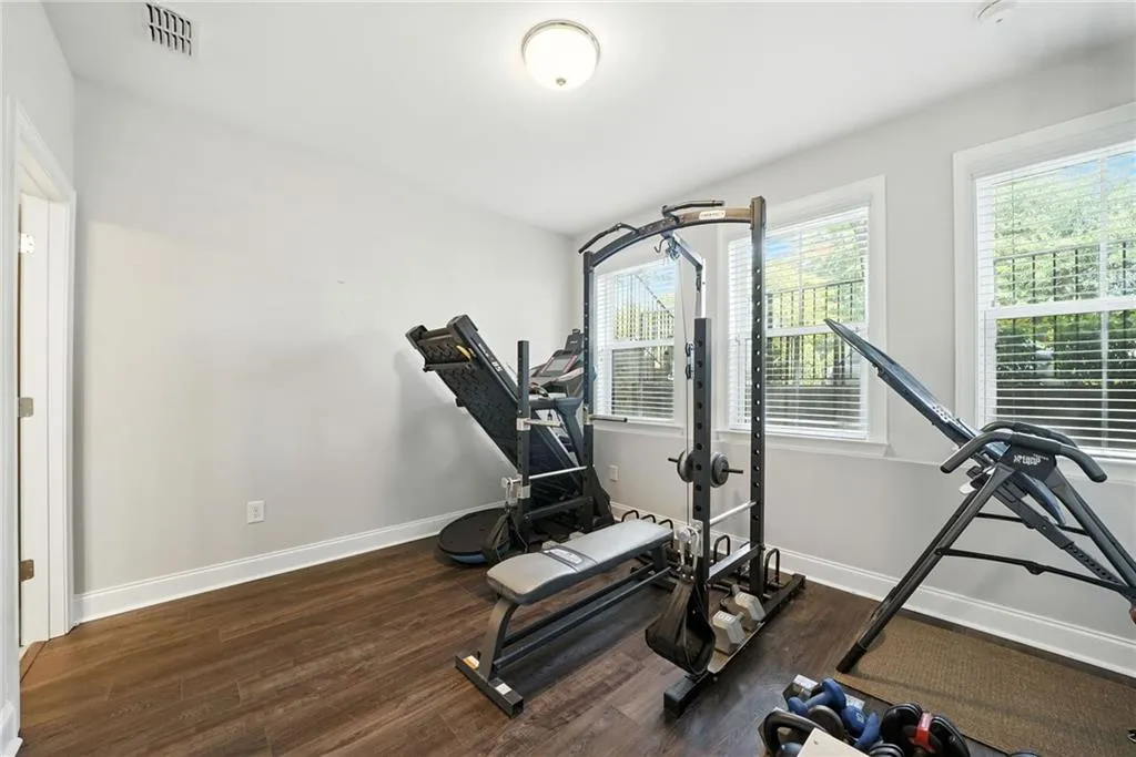 Exercise room featuring dark wood-style floors
