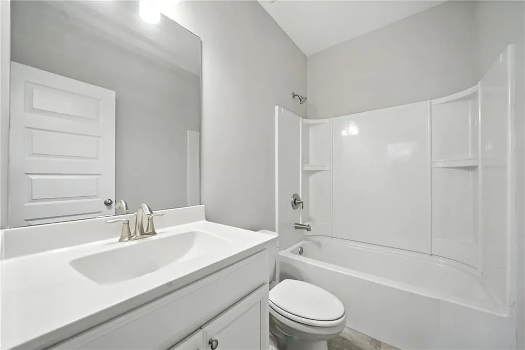 Bathroom with shower / bath combination and vanity
