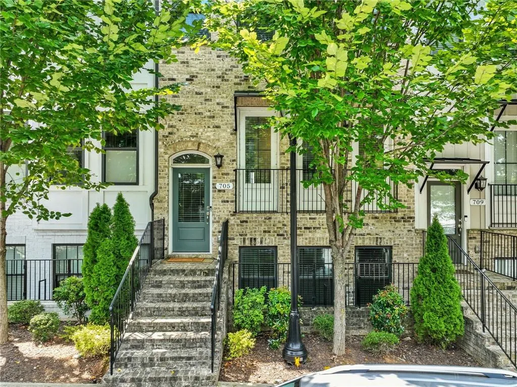 Property entrance featuring brick siding