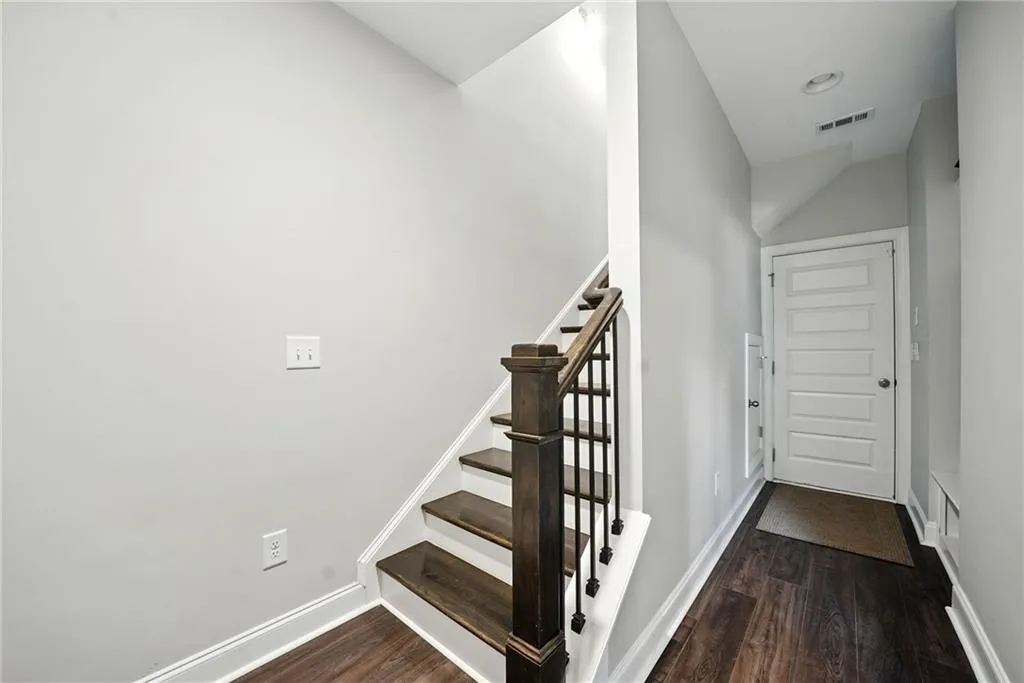 Stairs with wood finished floors and baseboards
