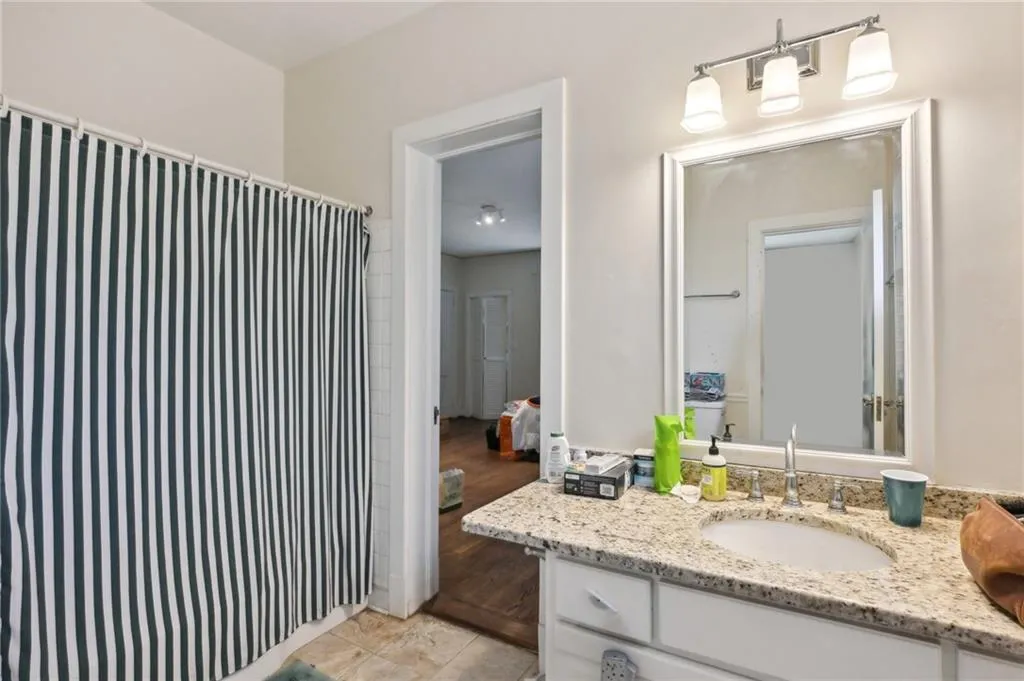 Full bathroom with granite vanity