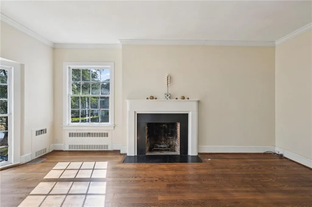 Living room with fireplace and gleaming hardwood floors