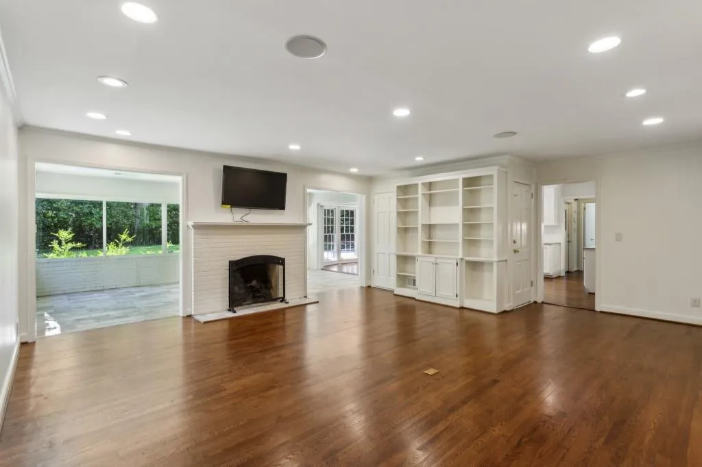 Beautiful Hardwood Floors carry throughout to a spacious and inviting Family Room, complete with a cozy Fireplace and Custom Built-In Bookshelves