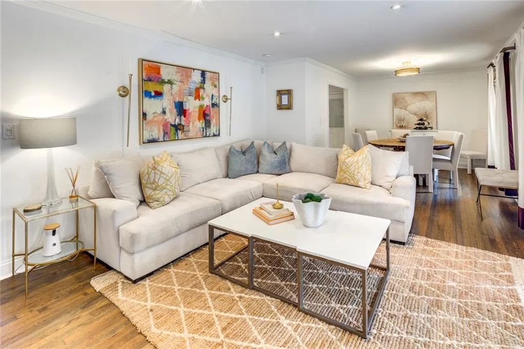 Living room featuring hardwood / wood-style floors and crown molding