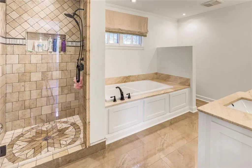 Bathroom featuring ornamental molding, tile flooring, vanity, and plus walk in shower