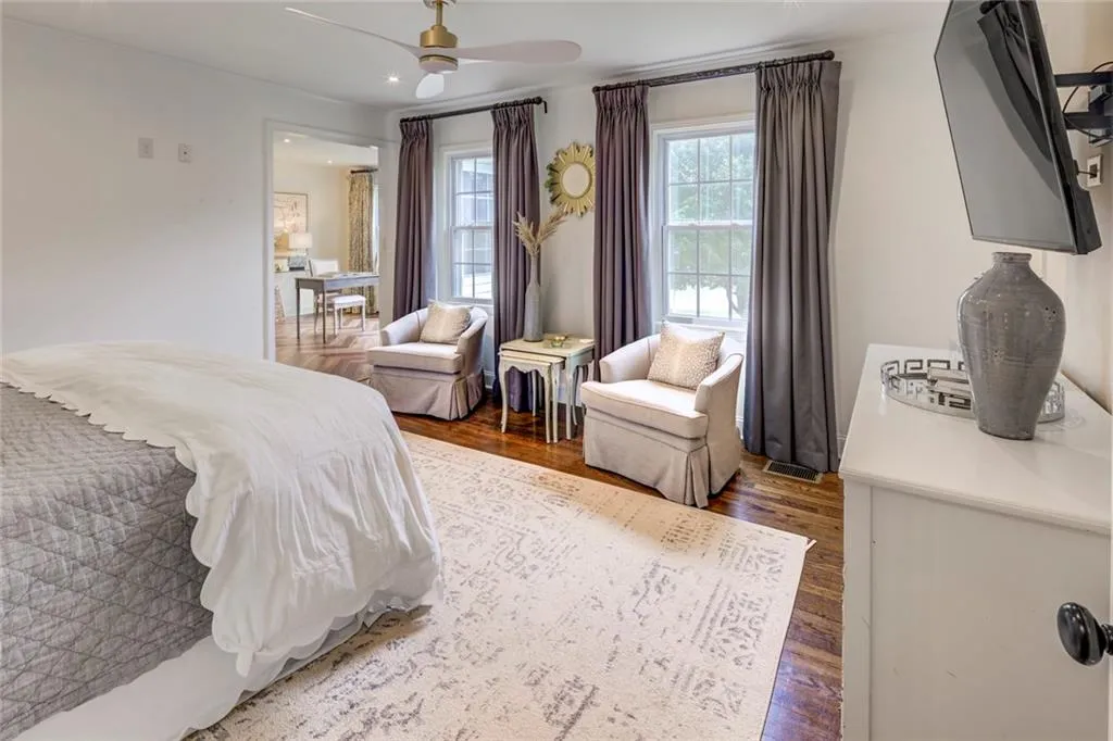 Bedroom with dark hardwood / wood-style floors and ceiling fan