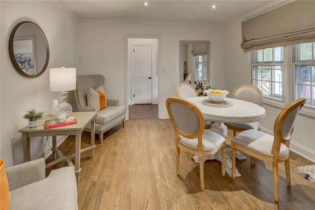 Dining area with ornamental molding and light wood-type flooring