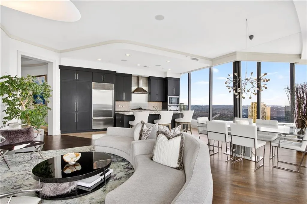 Living room with dark wood-style floors, a fireplace, and recessed lighting