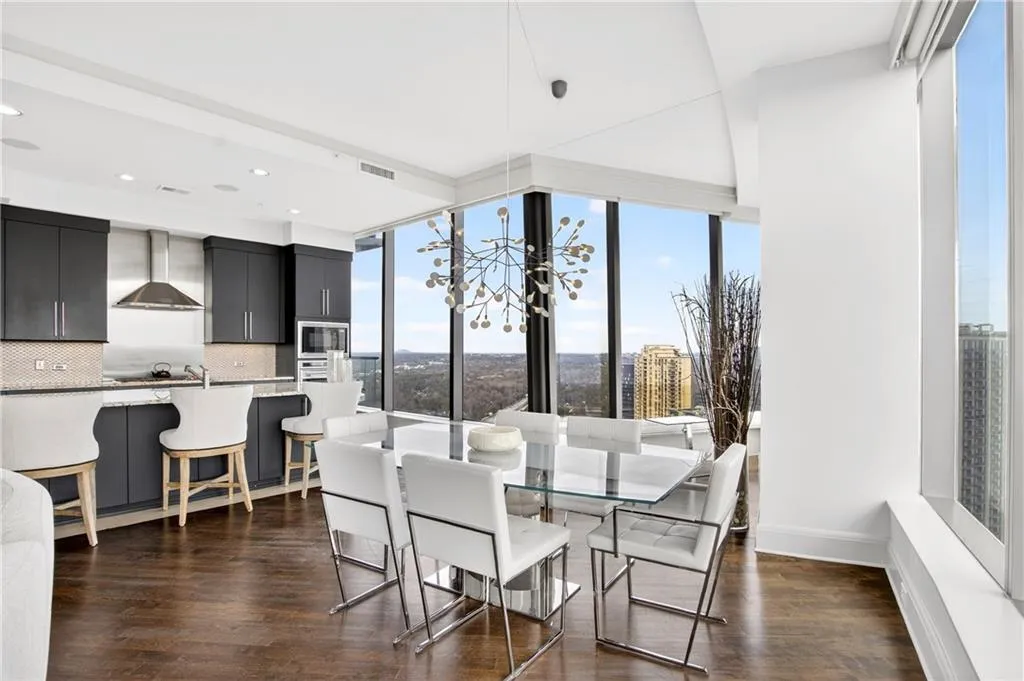 Dining space with a chandelier, dark wood-style floors, and recessed lighting