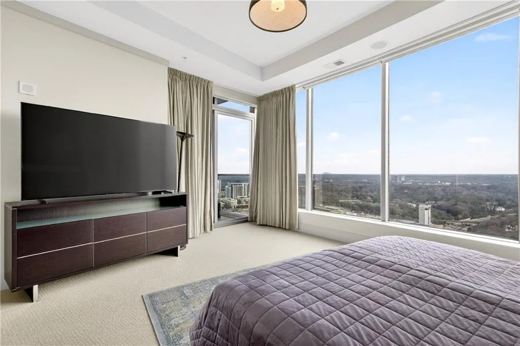 Bedroom with light carpet and access to outside