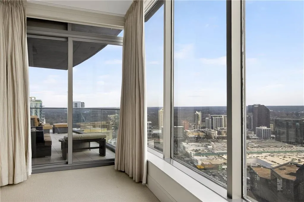 Sunroom / solarium featuring a view of city and plenty of natural light