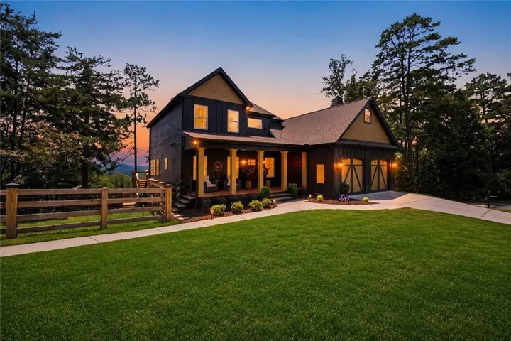 Craftsman-style home featuring a dark wood siding and gabled rooflines