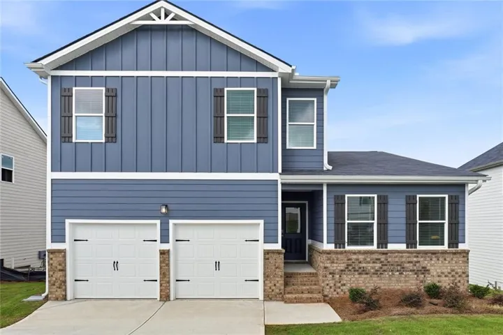 Contemporary two-story exterior featuring blue horizontal siding, vertical board and batten accents, and a contrasting dark roof