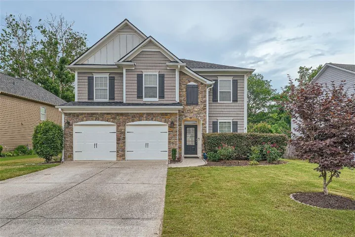 View of front of property with a garage and a front yard