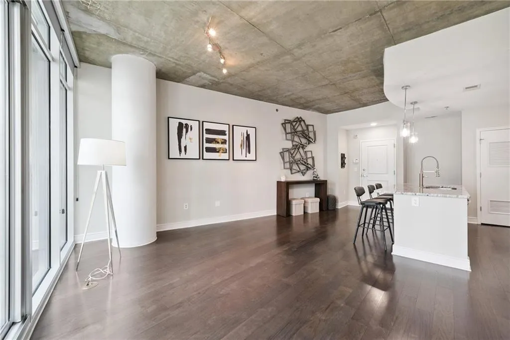 Living area with dark wood-type flooring and baseboards