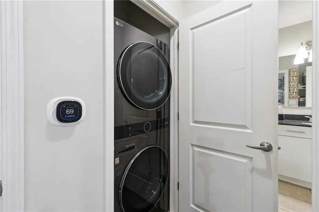 Laundry room featuring stacked washer / drying machine