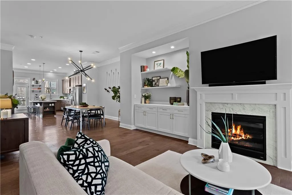 Custom built in cabinetry added with floating shelves to the left of the fireplace for optimal storage.