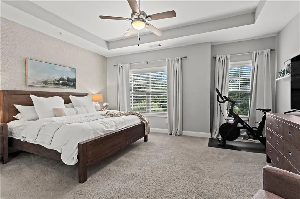 Primary suite offers tray ceilings making the room feel even larger than it already is