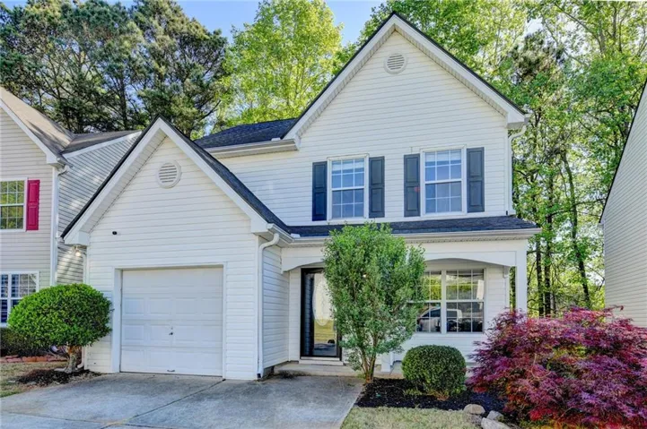White siding exterior with a dark roof