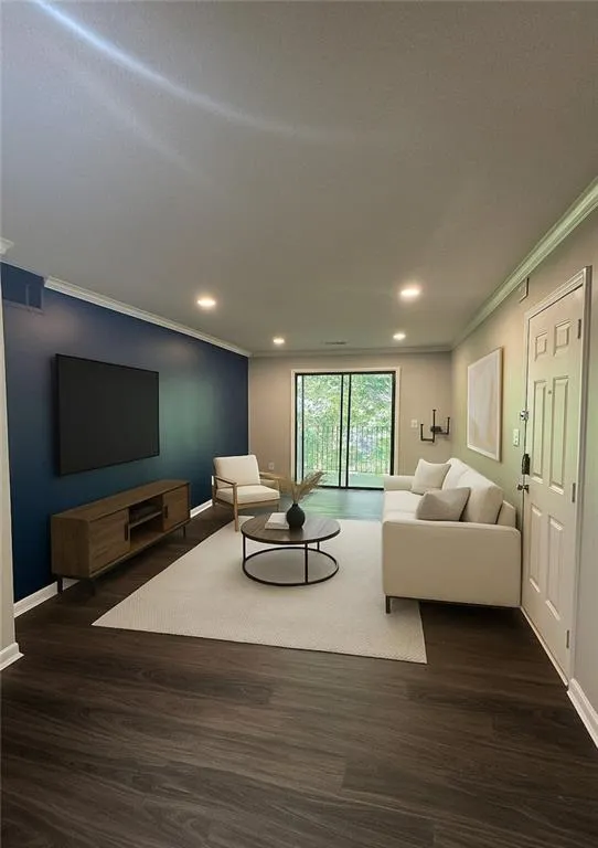 Living room featuring ornamental molding, dark wood finished floors, and recessed lighting Living room featuring ornamental molding, dark wood finished floors, and recessed lighting