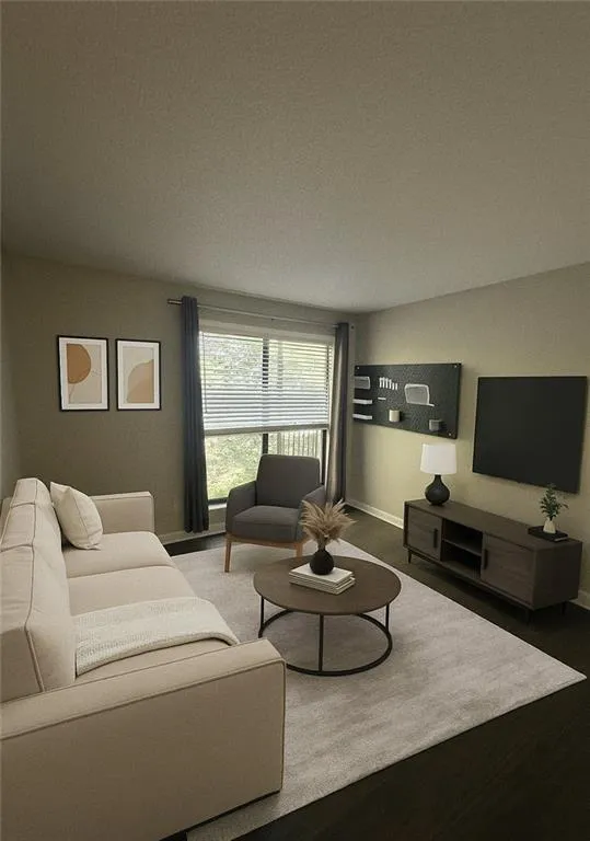 Living area with baseboards and wood finished floors Living area with baseboards and wood finished floors