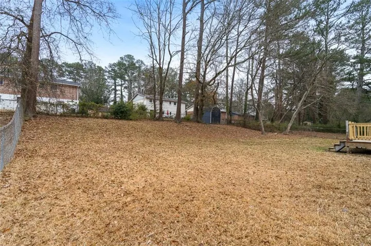 Expansive backyard with level grounds and mature tree line providing natural privacy and shade