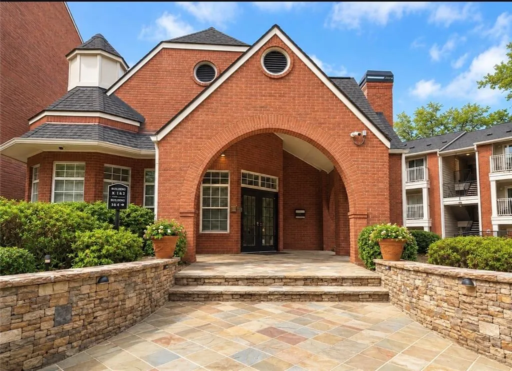 Brick facade entry featuring a prominent archway