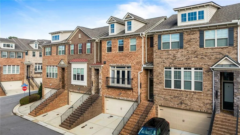 Traditional home with a residential view, brick siding, and an attached garage