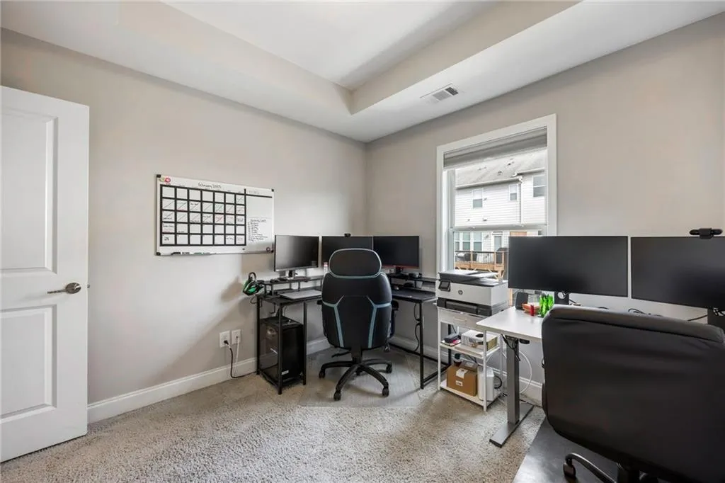 Office featuring baseboards and light colored carpet