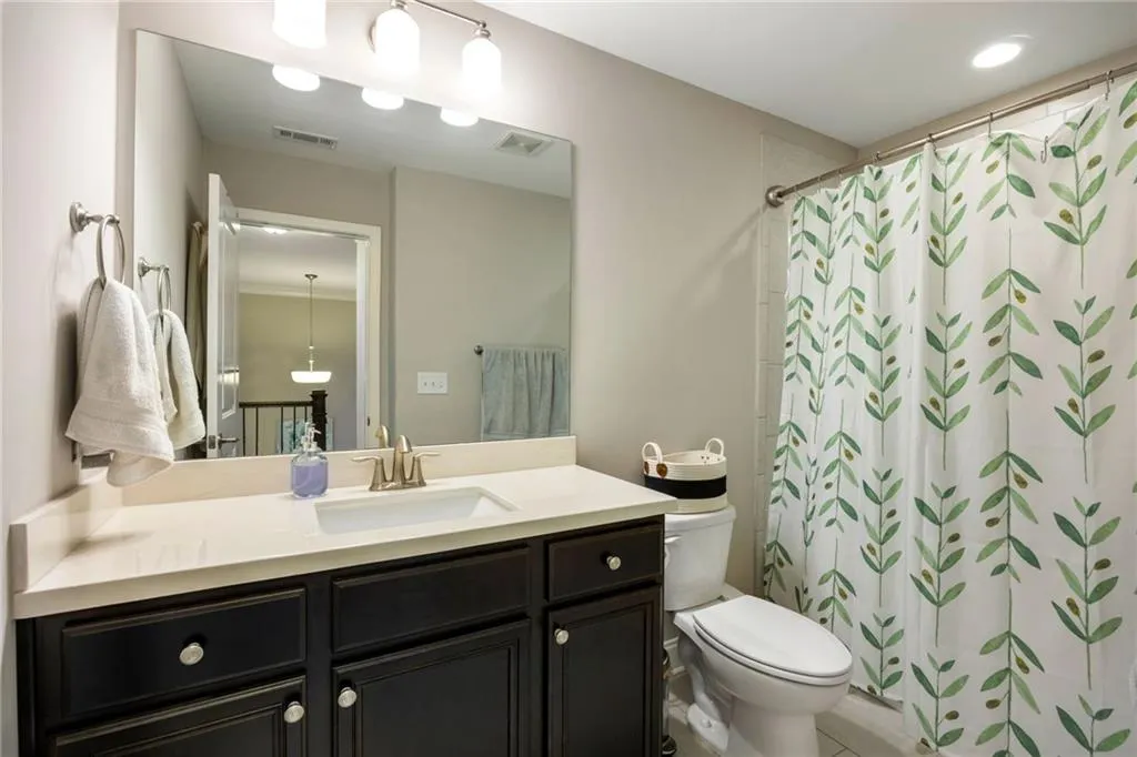 Bathroom featuring vanity and a shower with shower curtain