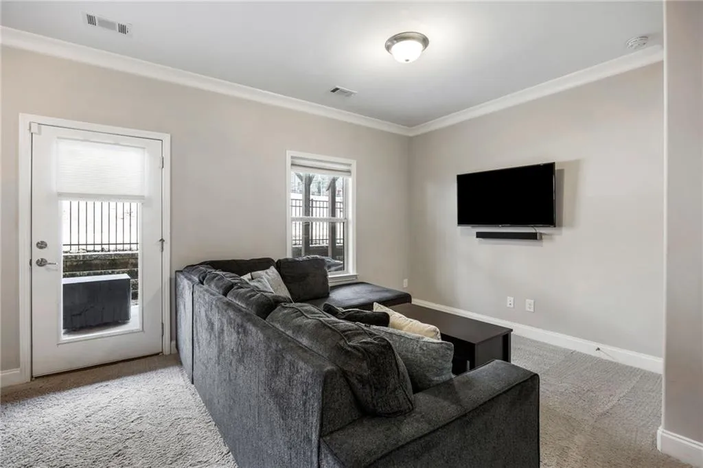 Living room featuring light carpet and crown molding
