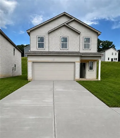 Two-story exterior with light gray siding and shake accents