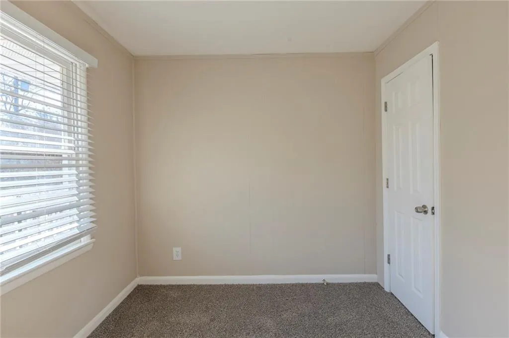 Carpeted spare room with baseboards
